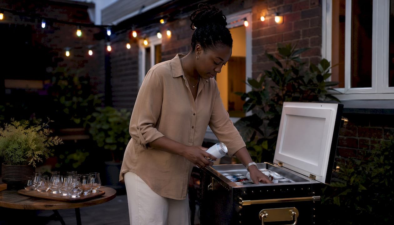 Woman storing craft beers in home fridge
