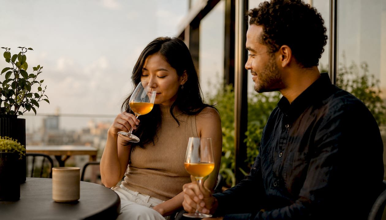 Couple tasting natural orange wine at winery