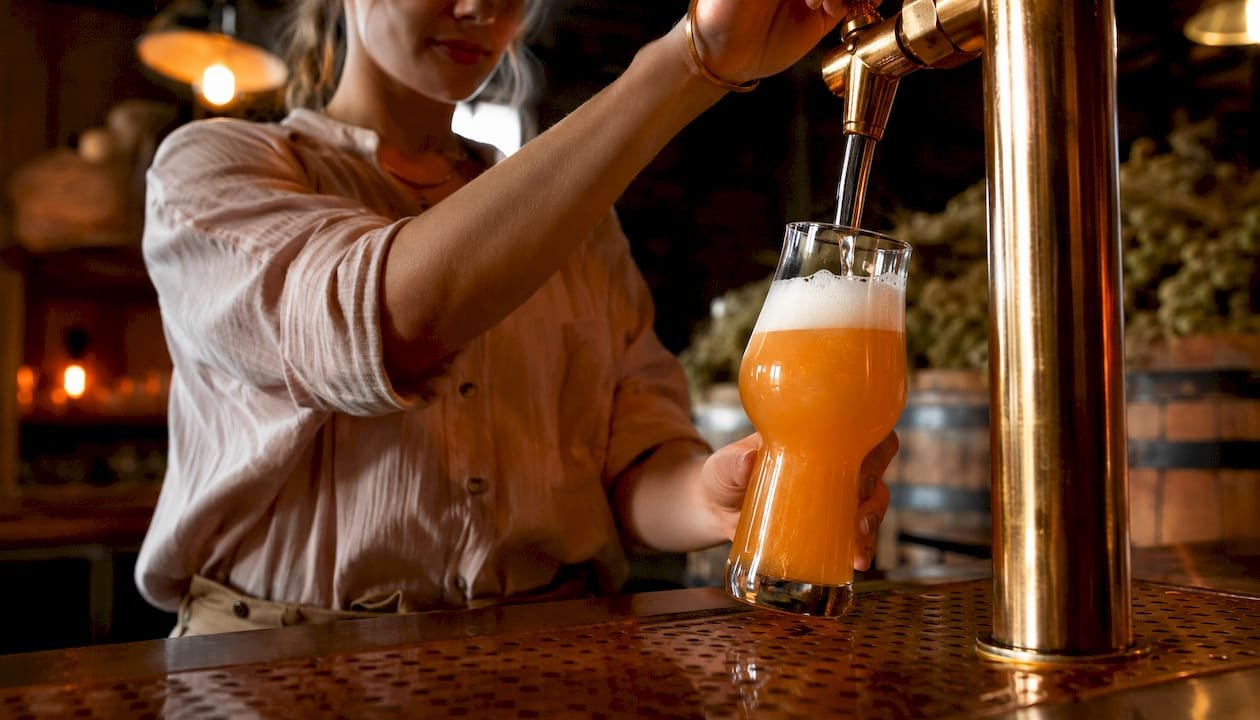 New England IPA pouring into glass in brewery