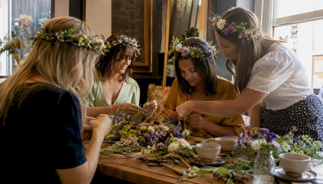 Women crafting flower crowns in Brighton workshop