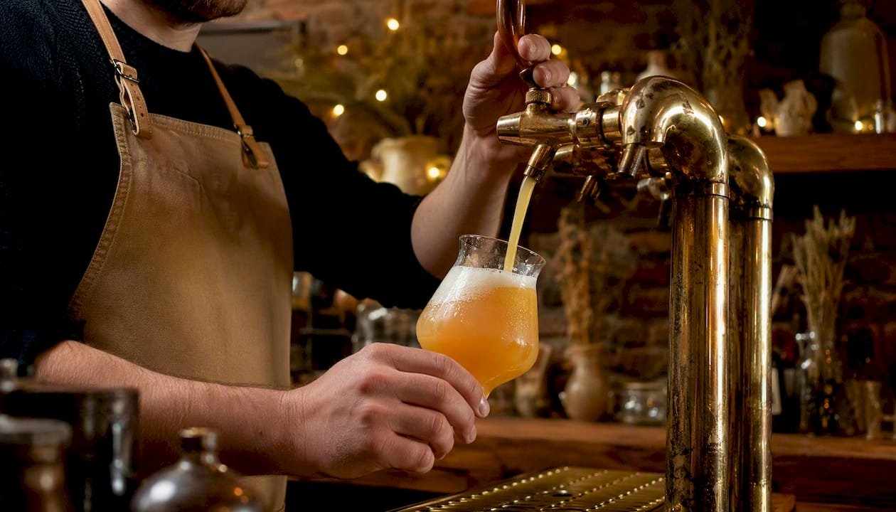 Close-up of hazy NEIPA pouring from tap